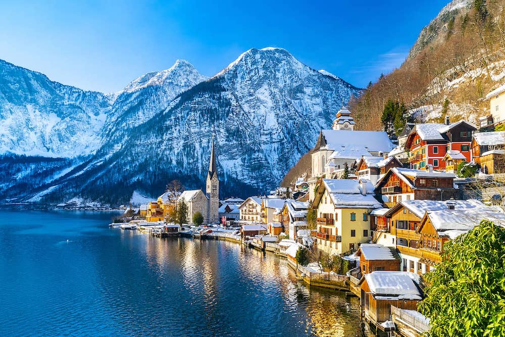 Hallstatt-Classic-postcard-view-of-famous-Hallstatt-lakeside-town-in-the-Alps-with-traditional-passenger-ship-on-a-beautiful-cold-sunny-day-
